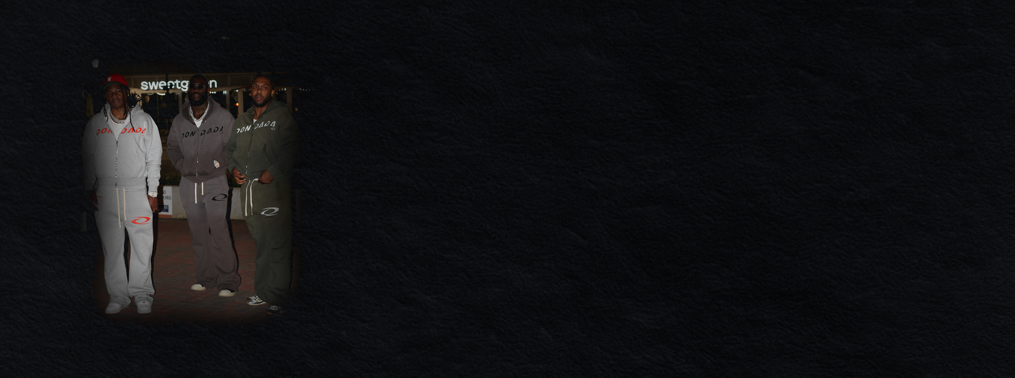 Three people in a dark room with minimal lighting